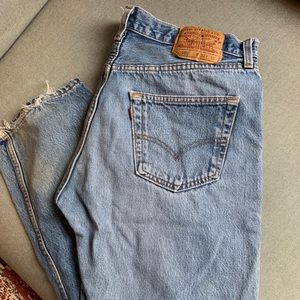 Levi’s 501 blue jeans with ripped knees